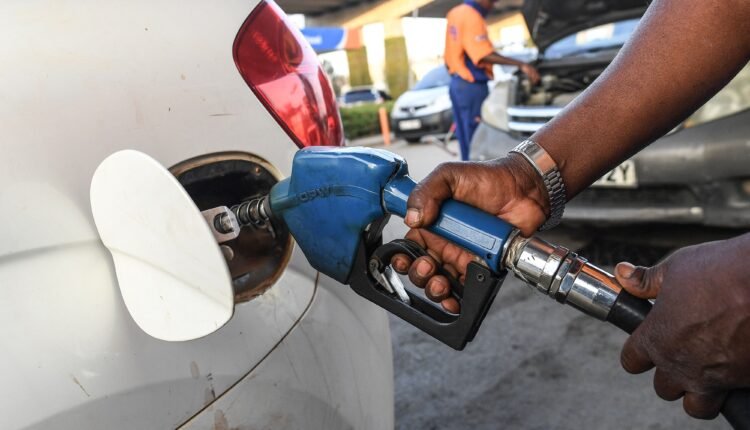 A pump attendant fills a car with fuel at the OlA petrol station, following country wide price hikes on March 15, 2022, in Nairobi. - (Photo by Simon MAINA / AFP) (Photo by SIMON MAINA/AFP via Getty Images)